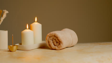 Still-Life-Of-Lit-Candles-With-Dried-Grasses-Incense-Stick-And-Soft-Towels-As-Part-Of-Relaxing-Spa-Day-Decor-1